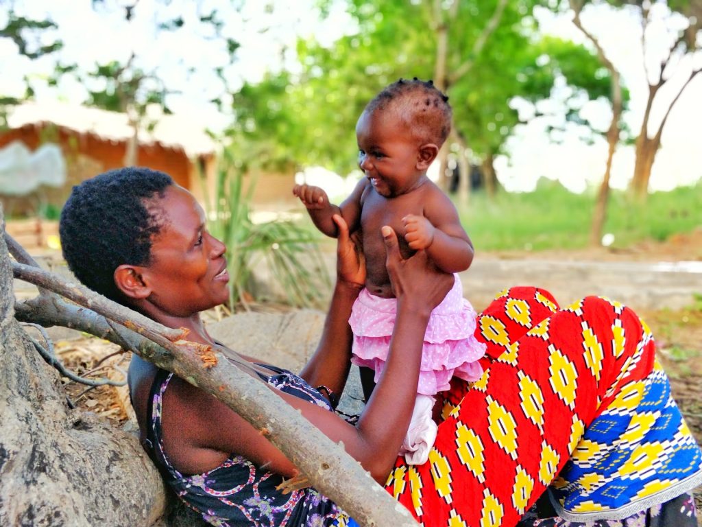 A happy young mother with her infant in Zomba, Malawi.