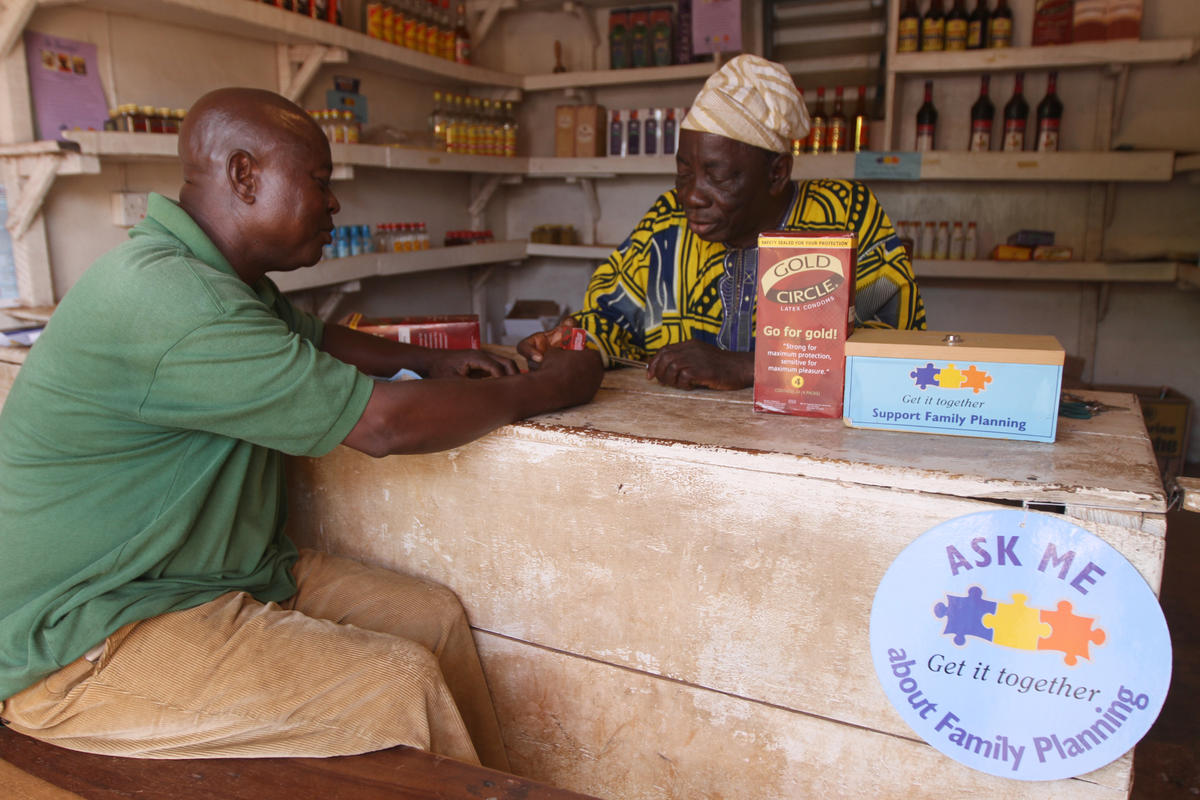 A patent medicine vendor speaks with his client about condom use in Oyo State, southwest Nigeria.
