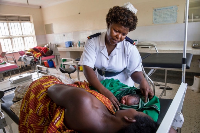 Head nurse Margie Harriet Egessa conducts a checkup on a woman who recently gave birth at Mukujju clinic, Uganda. 2014, Jonathan Torgovnik/Getty Images/Images of Empowerment