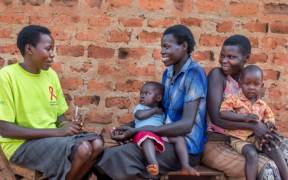 Community health worker Agnes Apid (L) with Betty Akello (R) and Caroline Akunu (center). Agnes is providing the women with counseling and family planning information. Image credit: Jonathan Torgovnik/Getty Images/Images of Empowerment
