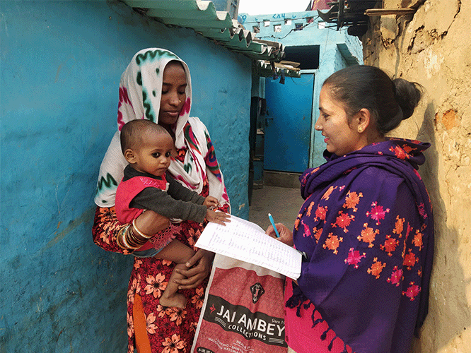 A woman listens carefully to the advice of an ASHA. This image is from "Fixed-Day Static Approach: Informed Choice and Family Planning for Urban Poor in India” IBP Implementation Story by Population Services International (PSI), India.