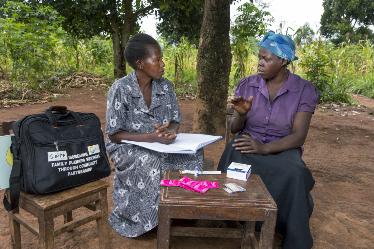 Community health worker during a home visit, providing family planning services and options to women in the community.