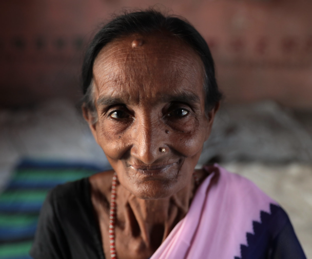 An older woman smiles at the camera