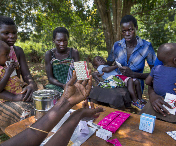 Women from the Young Mothers Group meeting and getting family planning information from a community health worker. The program is supported by Reproductive Health Uganda, with the goal to empower the women in the group, and provide them with family planning information.