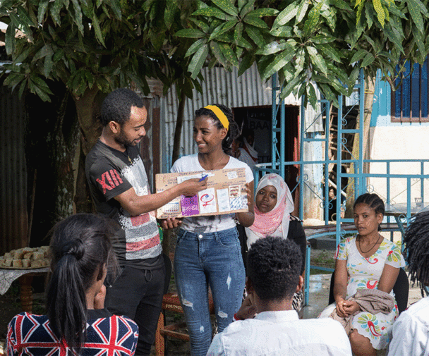 Two people lecturing on a female condom