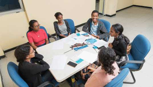Several youth advocates in Ethiopia meet around a conference table to discuss their work related to adolescent and youth sexual and reproductive health.. Photo credit: Maheder Haileselassie Tadese/Getty Images/Images of Empowerment