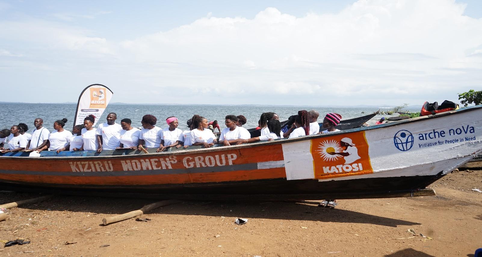 Several Kiziru Women’s Group members sit in their fishing boat for International Year of Artisanal Fisheries and Aquaculture 2022 on a beach. Photo Credit: KWDT