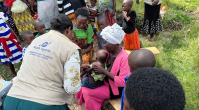 A healthcare worker with RCRA Uganda administering a vaccine to an infant. Photo credit: Rwenzori Center for Research and Advocacy (RCRA)