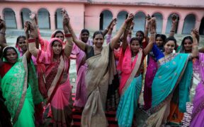 A group of Indian women raising their fists. Photo Credit: Images of Empowerment