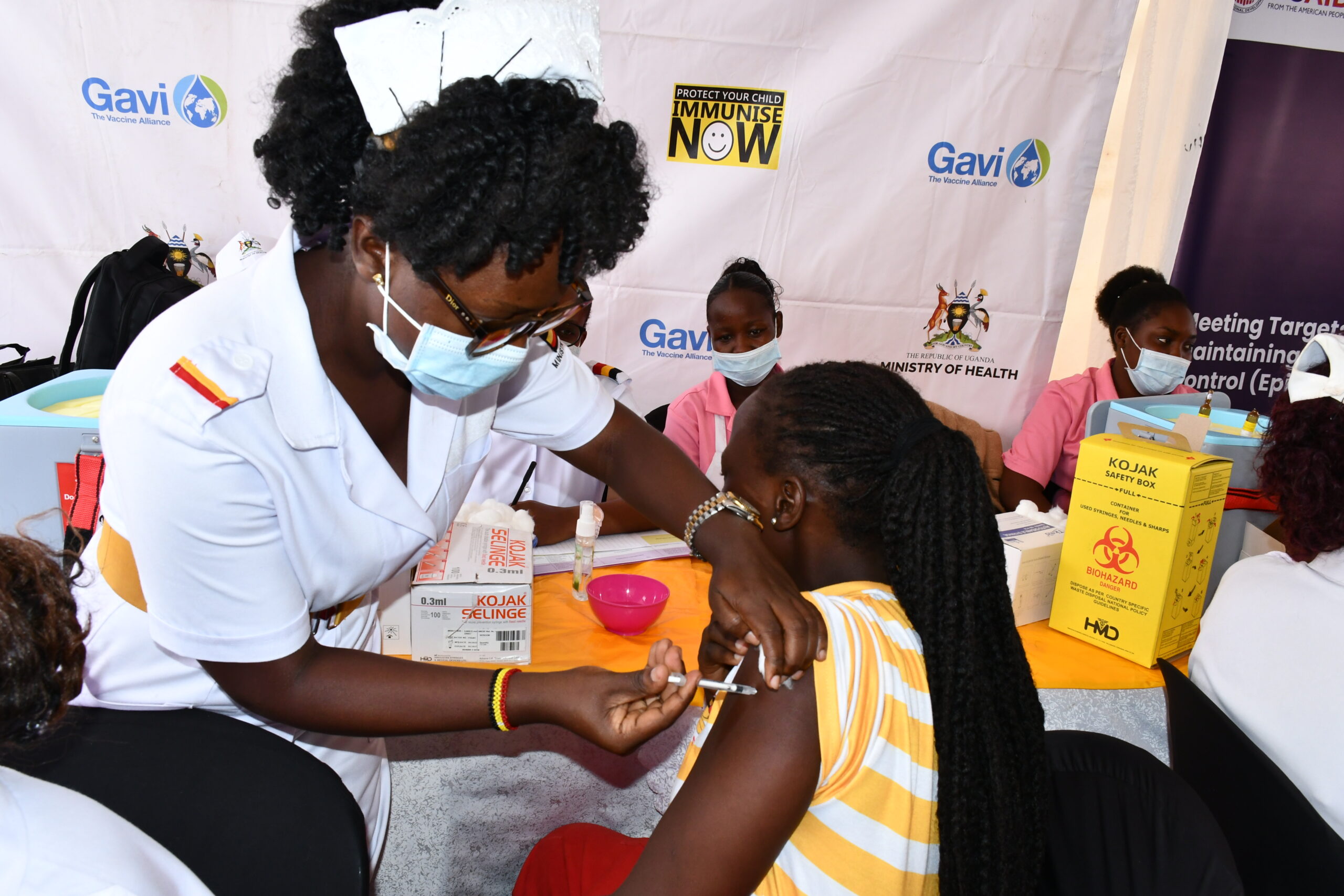 Nurse administering COVID-19 vaccine in Uganda