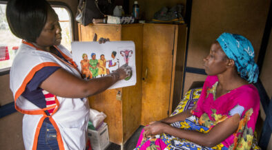 A woman learning family planning options like contraceptive implants at a rural village on the outskirts of Mombasa.