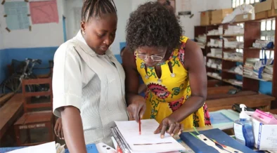 A staff of the Bombali District Health Management Team coaches a health worker.