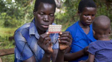 woman holding contraceptive pills