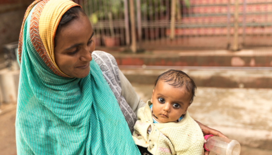 South Asian woman holding baby